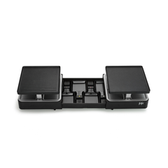 Grill électrique de table « Raclette Gourmet » doté de deux plaques de cuisson plates et carrées et de huit petits moules à raclette soigneusement rangés en dessous dans un système de rangement intégré, présenté sur fond blanc.